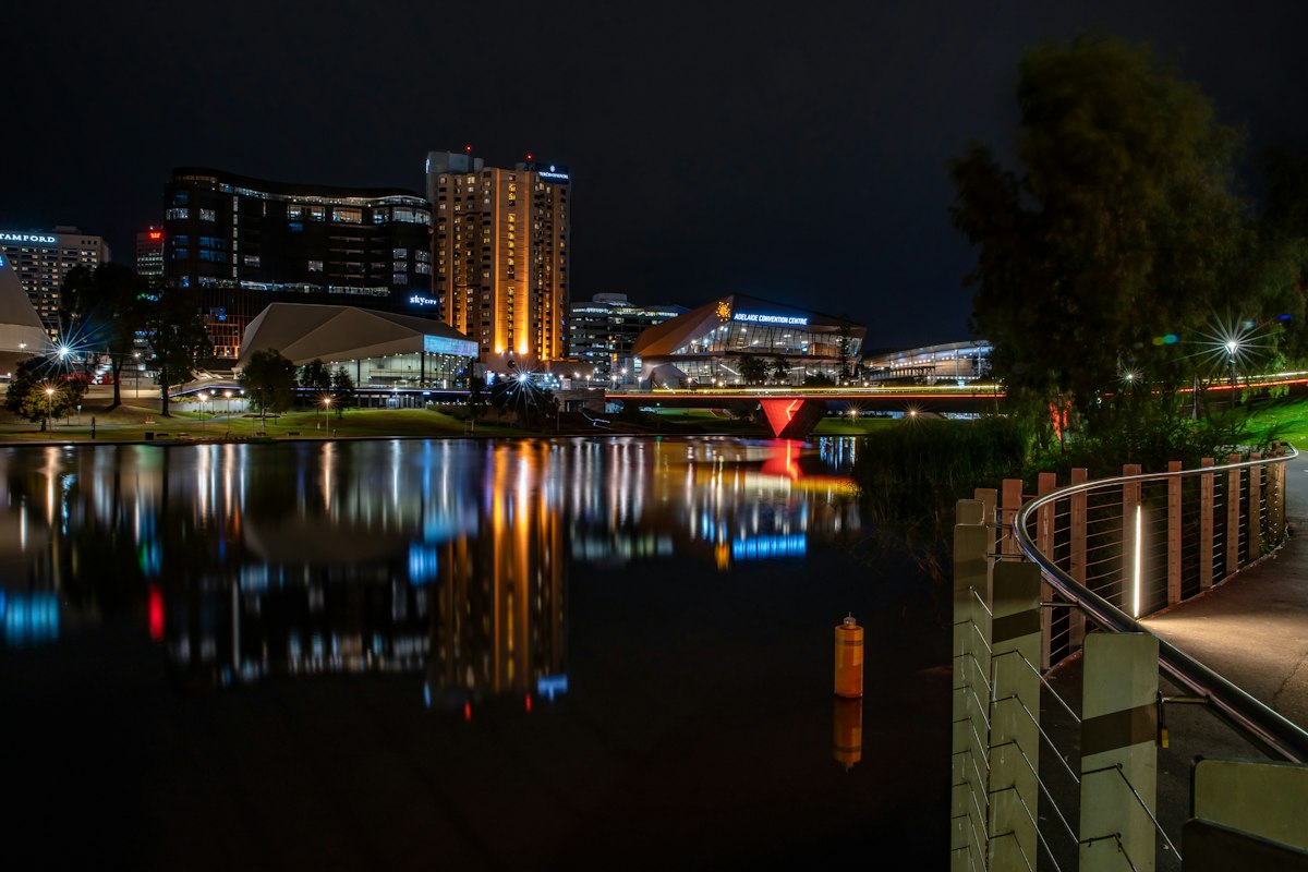 Adelaide riverbank and city lights reflecting on the River Torrens at night