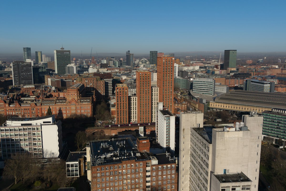 Manchester city centre skyline of brick and glass towers on a clear day